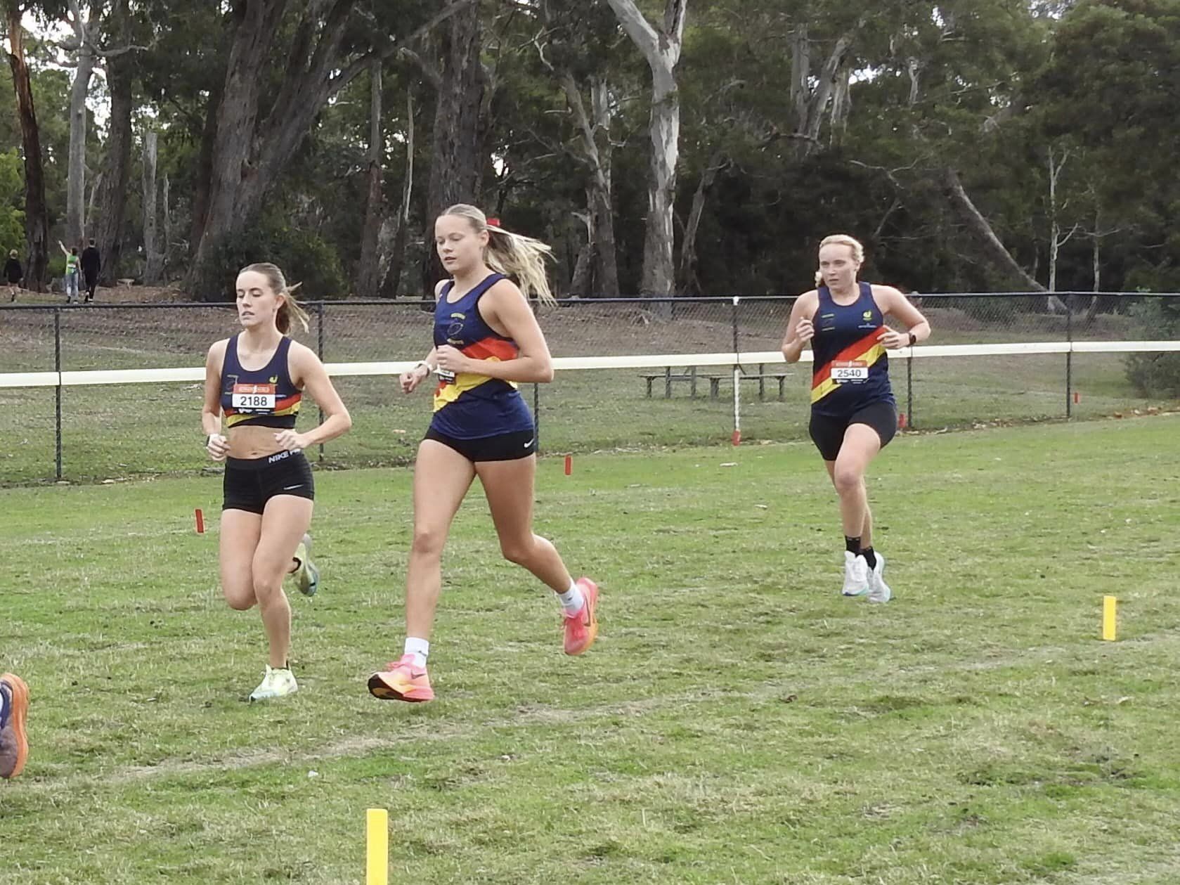 Sophie, Janae and Ebony running in a group